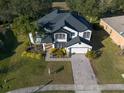 Beautiful two-story home with manicured lawn and lovely landscaping at 4431 Rock Hill Loop, Apopka, FL 32712