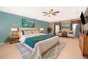 This spacious main bedroom has serene wall colors, a ceiling fan, and is nicely furnished at 516 Yellow Tail Pl, Chuluota, FL 32766