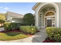 Side view showing the home's architectural details and manicured landscaping at 1657 Carillon Park Dr, Oviedo, FL 32765