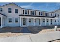 New construction townhomes with light blue paint, dark shutters, and covered entryways at 4204 Sadler Rd, Apopka, FL 32712