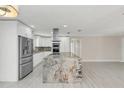 Modern kitchen with granite island, stainless steel appliances, and white cabinetry at 733 Preble Ave, Altamonte Springs, FL 32701