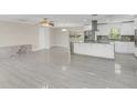 Open living area with light gray wood-look floors and lots of natural light at 733 Preble Ave, Altamonte Springs, FL 32701