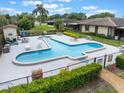 Community pool with unique design, tables, and chairs for residents' enjoyment at 10 Pilot Pl, Winter Haven, FL 33881