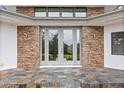Elegant front entrance with stone accents and tiled steps at 12550 Lakeshore Dr, Clermont, FL 34711