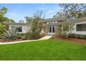 Inviting home exterior with manicured lawn and stone accents at 12550 Lakeshore Dr, Clermont, FL 34711