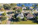 Aerial view of home showcasing its proximity to a tranquil lake and neighborhood streets at 12924 Lower River Blvd, Orlando, FL 32828