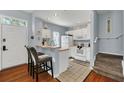 Small kitchen with white cabinets and breakfast bar at 2203 San Vittorino Cir # 102, Kissimmee, FL 34741