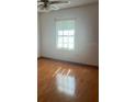The bedroom has hardwood floors and a ceiling fan with lots of natural light at 118 Cedar Rd, Ocala, FL 34472