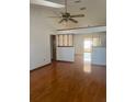 The living room features hardwood floors, a ceiling fan, and bright natural light at 118 Cedar Rd, Ocala, FL 34472