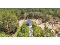 Aerial view of a modern home surrounded by lush greenery and tall trees, offering privacy at 13516 Sw 78 Pl, Dunnellon, FL 34432