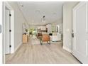Open-concept living area with wood floors, modern furniture, and ample natural light flowing through the space at 205 E 17Th St, Apopka, FL 32703