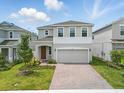 Inviting two-story home with a brick paver driveway and beautiful, green landscaping at 1162 Happy Forest Loop, Deland, FL 32720