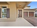 Inviting house exterior featuring a two-car garage and a covered entryway at 12983 Westside Village Loop, Windermere, FL 34786