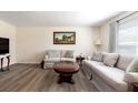 Comfortable living room with stylish sofas, a decorative coffee table, and a large window with natural light at 1311 Hartley Ave, Deltona, FL 32725