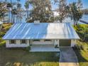Charming single-story home with a metal roof and access to a serene lake at 2239 River Ridge Rd, Deland, FL 32720