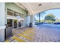 Welcoming building entrance with sliding doors, covered drop-off area and ample parking at 7383 Universal Blvd # 512, Orlando, FL 32819