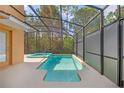 Inviting screened-in pool and spa offers a refreshing escape with a private backyard view at 2948 Banana Palm Dr, Kissimmee, FL 34747