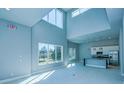 Bright, airy living room featuring high ceilings and large windows, seamlessly connecting to the modern kitchen area at 7760 Sandy Ridge Dr # 222, Kissimmee, FL 34747