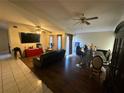 Cozy living room features hardwood floors, ceiling fans, and a decorative dining area at 2212 Atrium Cir, Orlando, FL 32808