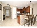 Kitchen boasts granite countertops, stainless steel appliances, and breakfast bar at 1720 Garden Sage Dr, Oviedo, FL 32765