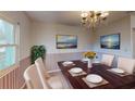 Formal dining room showcasing stylish furnishings and a decorative chandelier at 403 Tranquille Oaks Dr, Ocoee, FL 34761