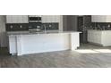 Modern kitchen featuring stainless steel appliances, a large island with granite countertops and white cabinetry at 121 S Cory Dr, Edgewater, FL 32141
