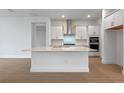 Modern kitchen with island, stainless steel appliances, and white cabinetry at 15086 Summer Harvest St, Winter Garden, FL 34787