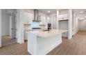 Bright kitchen featuring an island, stainless steel appliances, and white cabinets at 15086 Summer Harvest St, Winter Garden, FL 34787