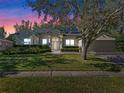 House exterior at dusk showcasing landscaping at 3954 Old Dunn Rd, Apopka, FL 32712