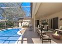 Relaxing pool area with covered patio, outdoor dining, and fire pit at 3954 Old Dunn Rd, Apopka, FL 32712