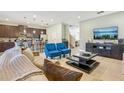 Open-concept living room features stylish furniture and flows into the modern kitchen at 471 Lasso Dr, Kissimmee, FL 34747