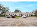 Exterior view of the townhouse complex showcasing parking and well maintained facade at 7707 Country Pl, Winter Park, FL 32792