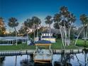 Stunning waterfront home featuring a private covered dock, lush palms, and a peaceful setting at 1043 Lemon Bluff Rd, Osteen, FL 32764