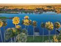 Beautiful aerial view of the waterway, the home's dock and lush palm trees reflecting in the clear water at 1043 Lemon Bluff Rd, Osteen, FL 32764