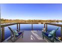 Waterfront views from private dock with Adirondack chairs perfect for relaxing by the water at 1043 Lemon Bluff Rd, Osteen, FL 32764