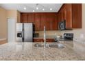 This kitchen features granite countertops, stainless steel appliances, and dark wood cabinets at 1054 Waterside Dr, Celebration, FL 34747