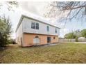 View of the backyard featuring a sliding glass door and a concrete patio at 2824 Corrigan Dr, Deltona, FL 32738