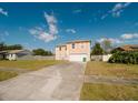 Inviting two-story home featuring a large front yard and an attached two car garage at 2824 Corrigan Dr, Deltona, FL 32738