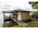 Covered boat dock featuring a storage shed and outdoor seating at 786 Antonette Ave, Winter Park, FL 32789