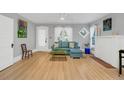 Inviting living room with hardwood floors, a cozy couch, and a decorative white fireplace at 786 Antonette Ave, Winter Park, FL 32789