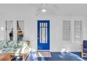 Bright sunroom with white walls, a blue floor, and a comfortable seating area by large windows at 786 Antonette Ave, Winter Park, FL 32789