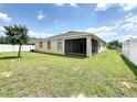 Spacious backyard featuring a screened-in patio and a pristine white fence, perfect for outdoor entertaining at 236 Barrington Dr, Haines City, FL 33844