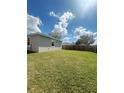 Spacious backyard featuring a large, well-maintained lawn and a sturdy wooden fence for privacy at 388 Chinaberry Ave, Oviedo, FL 32765