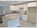 Modern kitchen featuring white cabinets and granite countertops at 6929 Central Ave, Mulberry, FL 33860