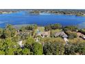 Stunning aerial view of waterfront homes featuring lush landscaping, private pools, and access to a beautiful lake at 2032 Dumas Dr, Deltona, FL 32738