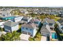 Charming, light blue two-story home with an attached two-car garage, pool, and well-maintained landscaping at 8279 Nemours Pkwy, Orlando, FL 32827