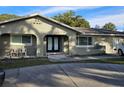 House exterior boasts a modern double door entry and well-manicured landscaping at 910 Rangeline Rd, Longwood, FL 32750