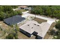 Overhead view of the tan-roofed home, highlighting the backyard and surrounding neighborhood at 1202 Alafia Way, Poinciana, FL 34759