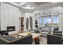 Stunning living room featuring a stone accent wall, fireplace, and beautiful views to the outdoor living space at 6009 Lady Bet Dr, Orlando, FL 32819