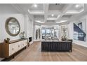 Bright and airy living room with tray ceilings, fireplace, and an open floor plan to the dining area at 6009 Lady Bet Dr, Orlando, FL 32819